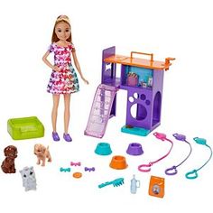 a barbie doll and her dog play with their pet house, including two puppies