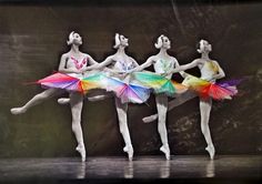 three ballerinas in colorful tutus and leotards