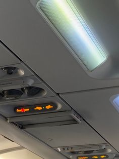 the lights on the ceiling are clearly visible for us to see in this plane's cabin