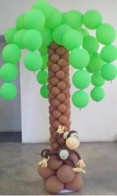 an image of a balloon tree with monkeys on it