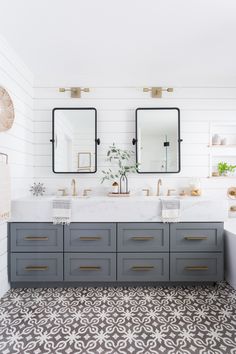 a bathroom with two sinks and mirrors on the wall