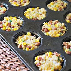 a muffin tin filled with corn and rice