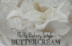 a white bowl filled with whipped cream on top of a wooden table and the words fluffy bakery style buttercream written in black