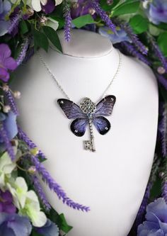 This is a must-have piece for all fairies! A unique and truly stunning purple butterfly winged key necklace, adorned with shimmering crystals, beads and a dash of silver fairy dust. The wings are approximately 7.5cm wide. Please note these wings are made in the same style as my other pieces - they are light and ethereally translucent. They are not fully opaque (see photos). This delicate array of fairy wings is really rather lovely. It is perfect for all fairy lovers - whether to be worn as part of a costume, or simply as a pendant for everyday wear. It is super light weight, and the wings are slightly flexible to touch. These wings are far more durable than their glassy appearance might suggest! Please note that the wings may grow cloudy over time when exposed to sunlight, heat, perspirat Purple Fairycore Jewelry For Gifts, Fairycore Purple Necklace For Gift, Fairycore Purple Jewelry As A Gift, Fairycore Butterfly Necklace As A Gift, Fairycore Butterfly Necklace For Gift, Fairycore Butterfly Necklace Gift, Fairycore Butterfly Charm Necklace Gift, Fairycore Butterfly Charm Necklace For Gift, Purple Butterfly Wings