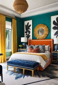 a bedroom with green walls, blue and yellow accents and artwork on the wall above the bed