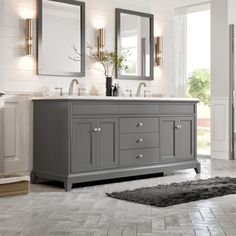 a bathroom with double sinks and mirrors on the wall, along with a gray rug