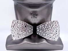 Big Payoff (Classic) | Big Business Collection (Lower Price at CREATEDINCALI.COM) Introducing a stunning bowtie that is sure to turn heads. With a captivating Silver textured design adding an artistic flair and a wooden base seamlessly bringing in a touch of nature, this bowtie is a true masterpiece. This isn't just a bowtie; it's your statement piece. Wear it to that special event, that wedding you're attending, or simply to make your everyday look pop. Each one is made with love and care, ensu Elegant Silver Suit And Tie Accessories For Party, Elegant Adjustable Silver Suit And Tie Accessories, Silver Tie As A Gift, Adjustable Silver Suit And Tie Accessories For Black Tie, Silver Adjustable Accessories For Black Tie Suit, Silver Ties For Black Tie Events, Silver Tie For Gift, Silver Ties For Black Tie Occasions, Adjustable Silver Ties For Black Tie Events