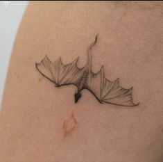 a black and white photo of a leaf on the back of a woman's shoulder