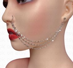 a woman's face with chains on her neck and nose piercings attached to it