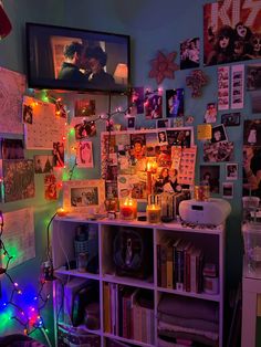 a room with many pictures and lights on the wall