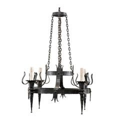 a chandelier with five candles hanging from it's center and two arms