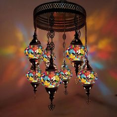 an ornate chandelier with multicolored glass balls hanging from it's sides