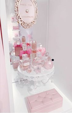 a table with perfume bottles on it and a mirror in the background