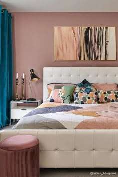 a bedroom with pink walls and white furniture