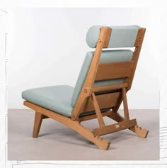 a wooden chair with a blue cushion on it