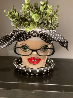 a woman's head with glasses and a polka dot hat on top of it