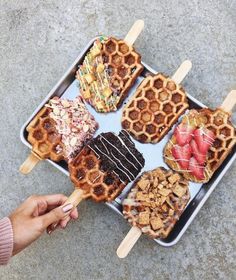 waffles and other desserts are being served on skewers