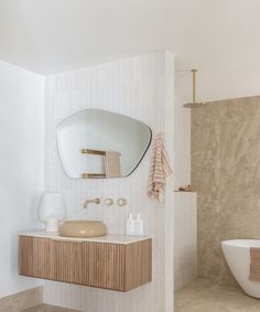 a bathroom with a sink, mirror and bathtub