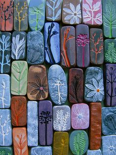 an image of some colorful rocks with words on it and the caption for pick a flower or plant and lay on top of a rock to make an imprint in the clay