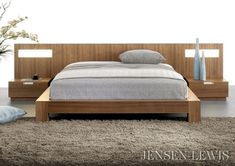 a bed with two nightstands and a night stand on top of it in a bedroom