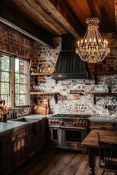 a kitchen with brick walls and wooden floors, chandelier hanging from the ceiling