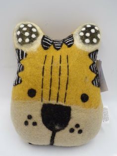 a stuffed animal that is yellow and black with white polka dots on it's ears