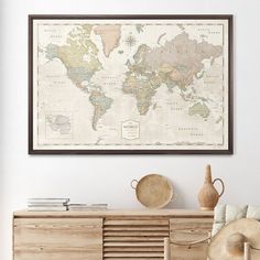 an old world map hangs on the wall above a dresser