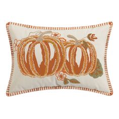 an orange and white pillow with two pumpkins on it