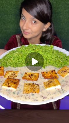 a woman is holding a plate with food on it and she has her hands in front of the plate