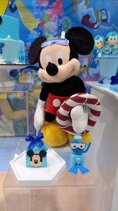 a mickey mouse stuffed animal sitting on top of a table