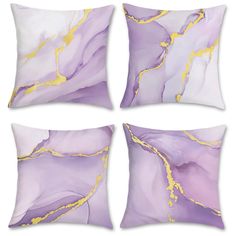 four purple and gold pillows on white background