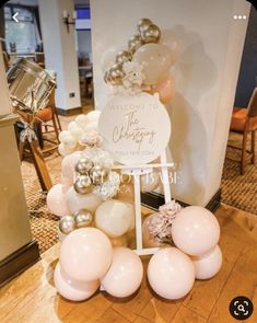 balloons and decorations are arranged on the floor for a welcome sign at a wedding reception