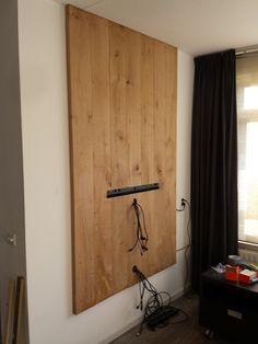 a room with a wooden door and some wires