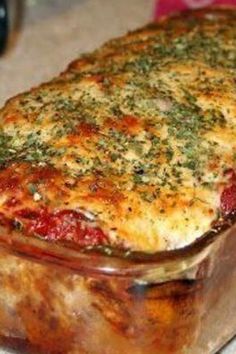 a casserole dish with meat and vegetables in it sitting on a counter top