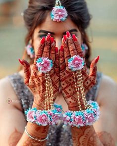 a woman is holding her hands up to show the hendi designs on her hands