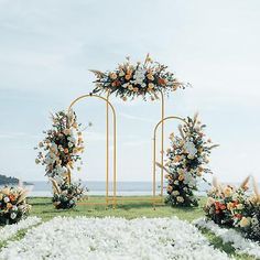 an outdoor wedding setup with flowers and greenery