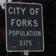 a black and white sign that says city of forks population