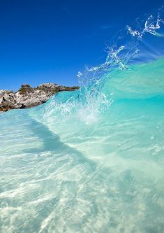 the water is very clear and blue with some waves coming in to shore on it