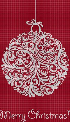 a cross stitch christmas ornament hanging on a string