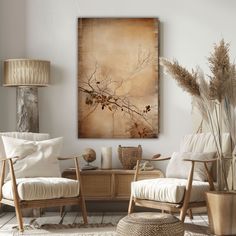 a living room with two chairs and a coffee table in front of a painting on the wall