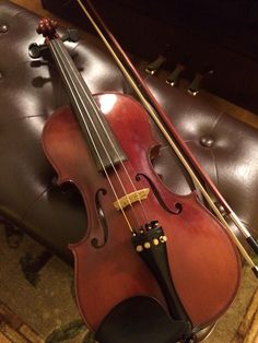 a violin sitting on top of a chair