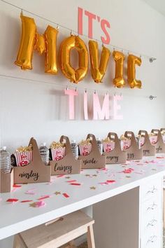 it's movie time party decorations and balloons on the wall at a birthday party