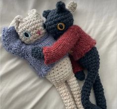 two crocheted stuffed animals laying on top of each other