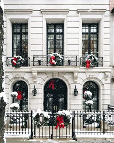 a large white building with red bows on it's windows