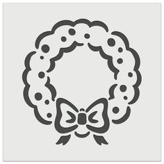 the silhouette of a wreath with a bow is shown in black and white on a gray background