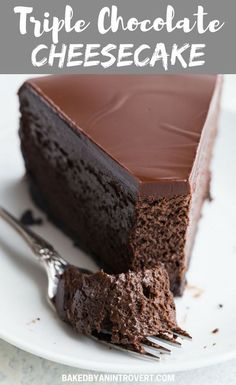 a piece of chocolate cheesecake on a white plate with a fork next to it