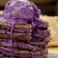 a stack of pancakes covered in purple icing