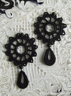 two black crochet earrings with tears hanging from them