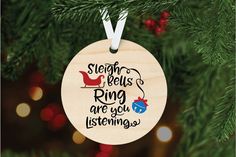 a wooden ornament hanging from a christmas tree with the words sleigh bells ring are you listening?