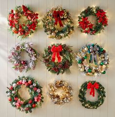 christmas wreaths are hung on the wall with lights